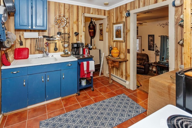 75 Brown Rd, Howell, NJ 07731 - kitchen with blue cabinets, baseboard heating, dark tile patterned flooring, crown molding, and light countertops