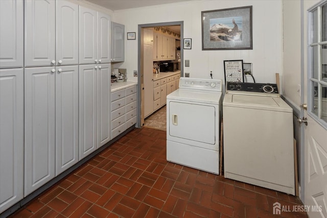 75 Brown Rd, Howell, NJ 07731 - laundry area featuring cabinet space, washer and clothes dryer, and brick patterned flooring