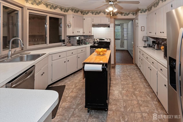 75 Brown Rd, Howell, NJ 07731 - kitchen with appliances with stainless steel finishes, a ceiling fan, backsplash, and white cabinetry