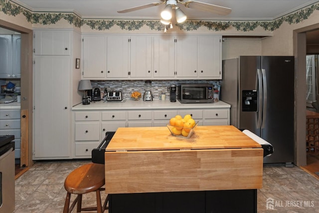 75 Brown Rd, Howell, NJ 07731 - kitchen featuring appliances with stainless steel finishes, a ceiling fan, white cabinetry, decorative backsplash, and wooden counters