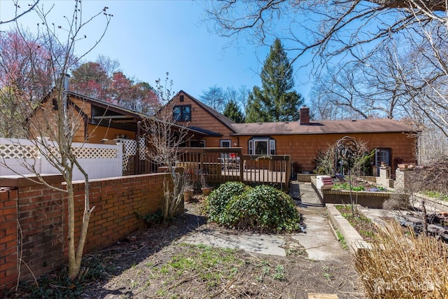 75 Brown Rd, Howell, NJ 07731 - back of property with a chimney and a wooden deck