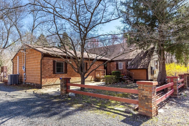 75 Brown Rd, Howell, NJ 07731 - view of front of house featuring a fenced front yard, brick siding, and roof with shingles