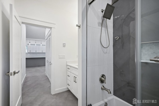 bathroom with vanity and tiled shower / bath combo