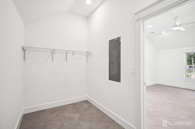 spacious closet featuring electric panel, ceiling fan, and vaulted ceiling