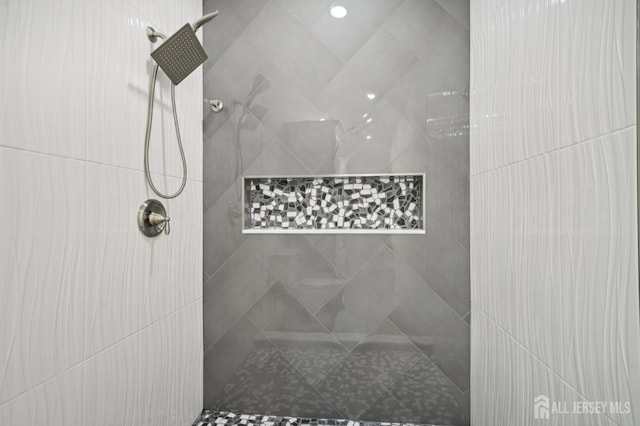 bathroom with tiled shower