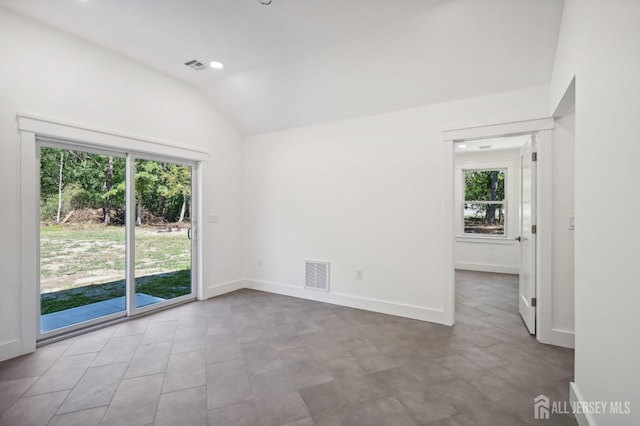 unfurnished room featuring vaulted ceiling