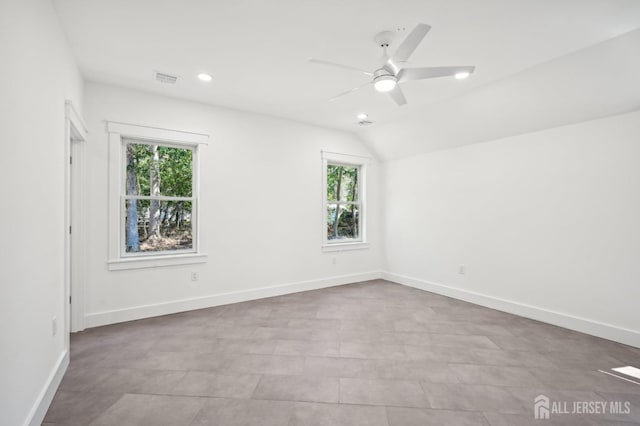 unfurnished room featuring plenty of natural light, ceiling fan, and lofted ceiling