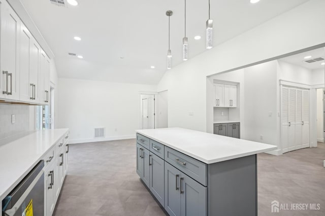 kitchen with pendant lighting, a center island, gray cabinets, and white cabinetry