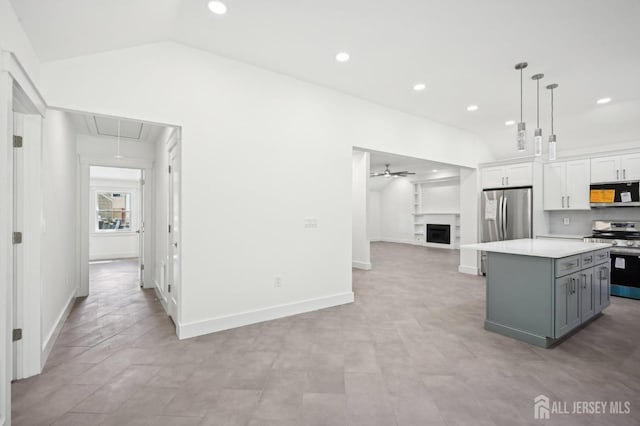 kitchen with white cabinetry, ceiling fan, stainless steel appliances, gray cabinets, and a kitchen island