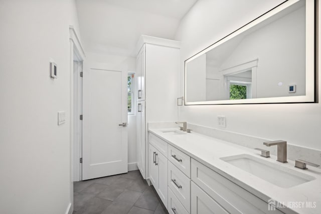 bathroom featuring tile patterned floors, vanity, and lofted ceiling