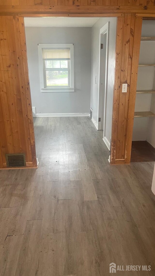 144 Inman Ave, Colonia, NJ 07067 - corridor with wood finished floors, baseboards, and wood walls