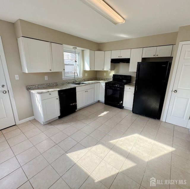 kitchen featuring light tile patterned floors, white cabinets, black appliances, under cabinet range hood, and a sink