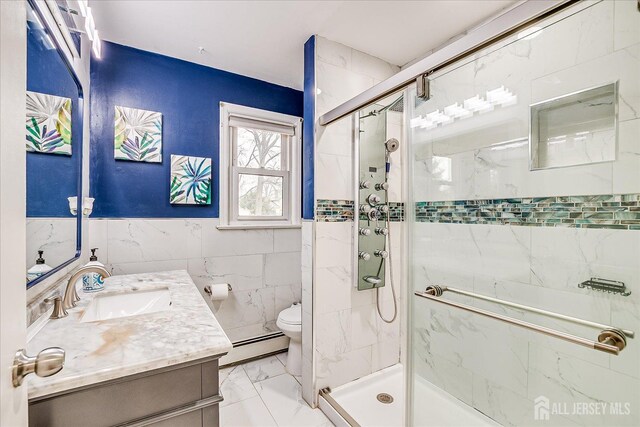 full bathroom featuring marble finish floor, tile walls, a baseboard radiator, toilet, and a shower stall