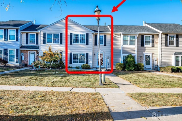 view of property featuring a residential view and a front lawn