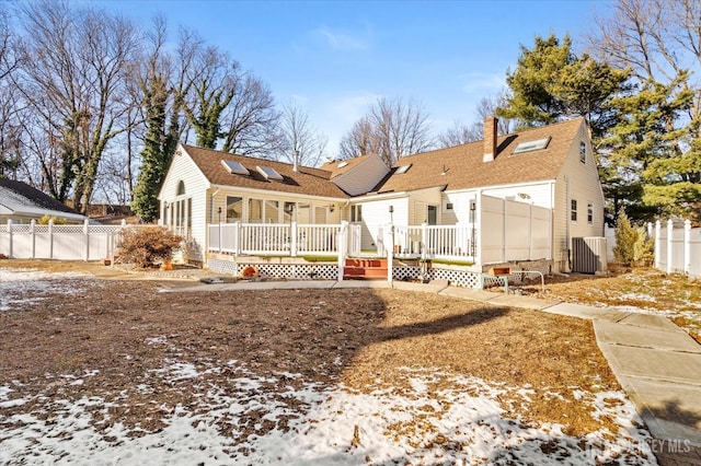 snow covered property featuring central AC and a deck