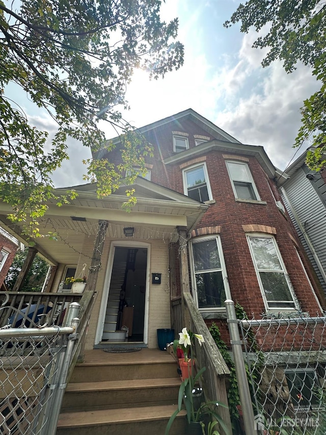290 Redmond St, New Brunswick, NJ 08901 - view of front facade featuring brick siding and covered porch