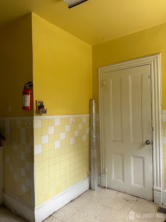 290 Redmond St, New Brunswick, NJ 08901 - bathroom featuring tile walls and wainscoting