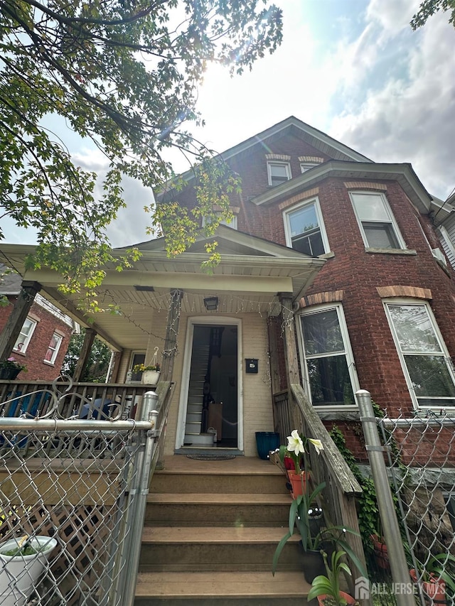 290 Redmond St, New Brunswick, NJ 08901 - view of front facade with brick siding and a porch