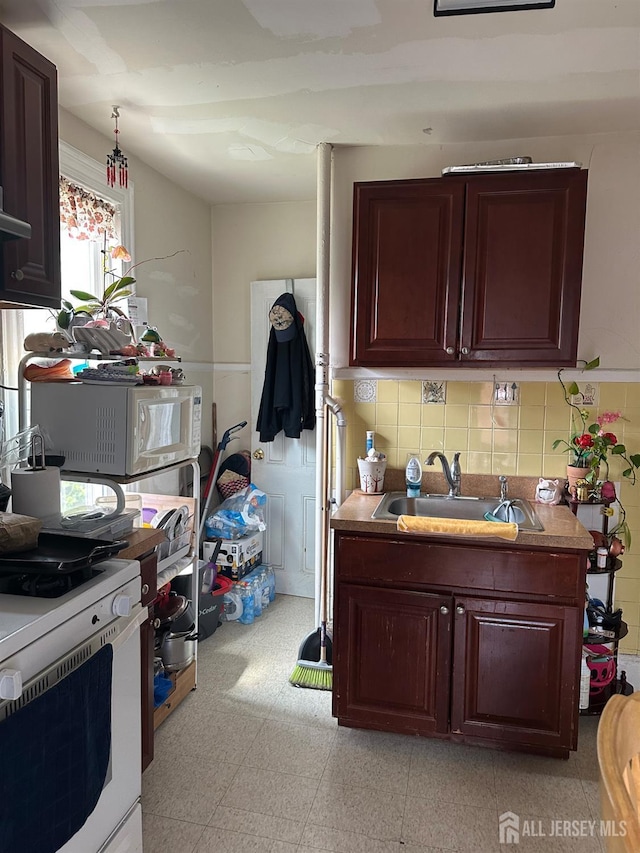 290 Redmond St, New Brunswick, NJ 08901 - kitchen with white appliances, backsplash, and light countertops