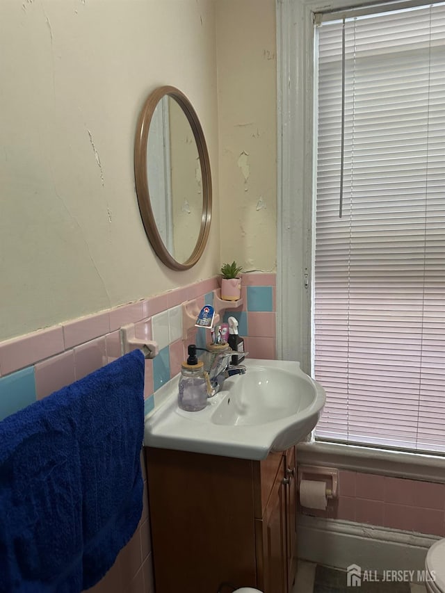 290 Redmond St, New Brunswick, NJ 08901 - half bathroom featuring vanity, tile walls, and a wainscoted wall