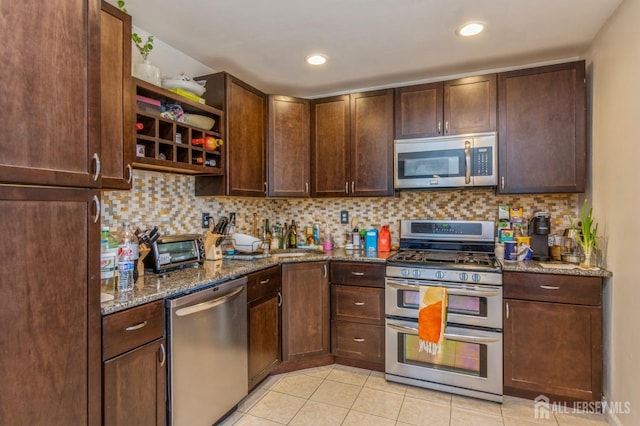 kitchen featuring tasteful backsplash, appliances with stainless steel finishes, open shelves, and dark stone counters