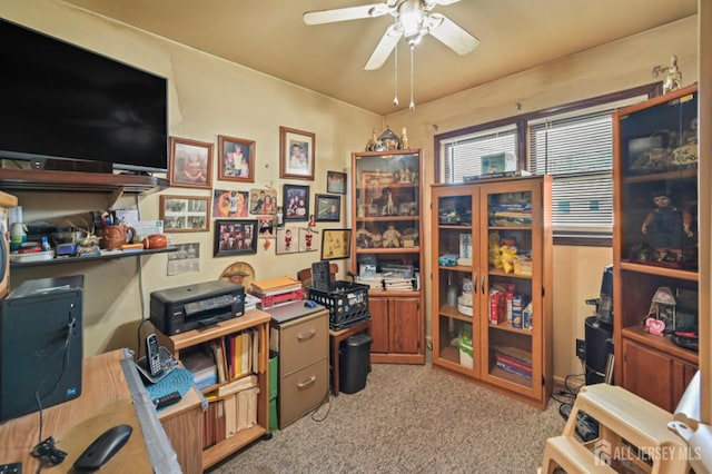 home office featuring light carpet and ceiling fan