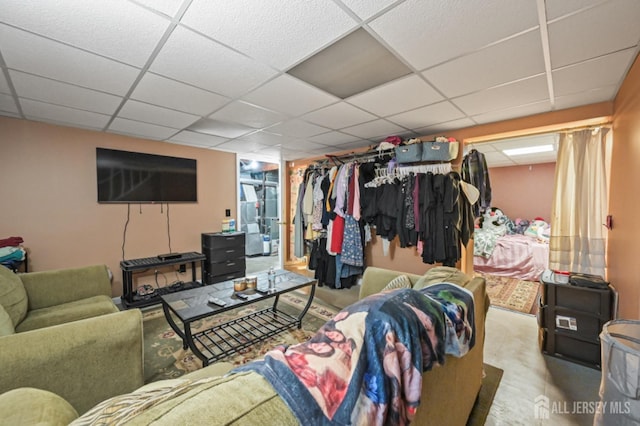 carpeted living room with a drop ceiling