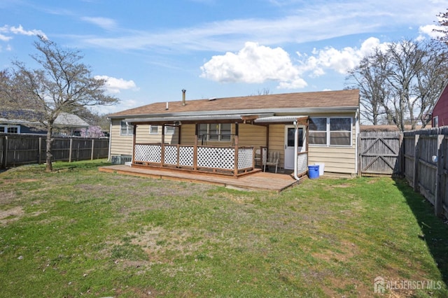 rear view of property featuring a deck and a gate