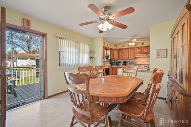 dining area featuring baseboards and a ceiling fan