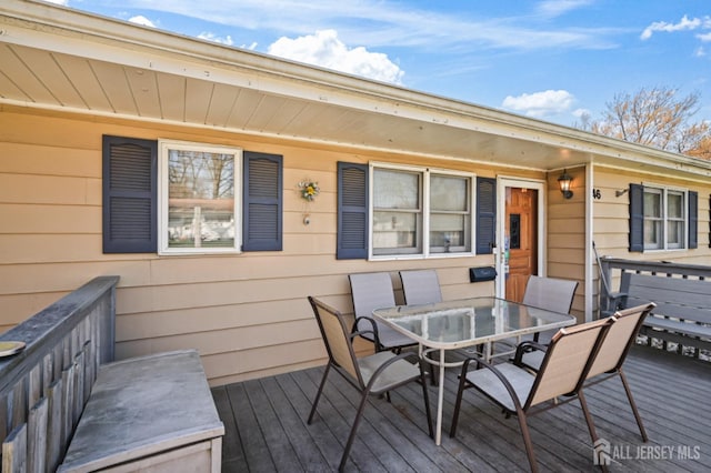 wooden deck featuring outdoor dining space