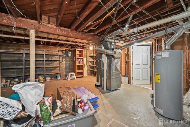 unfinished below grade area featuring heating unit and gas water heater