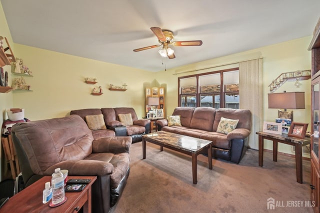 carpeted living area with ceiling fan