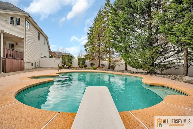 view of pool featuring a fenced backyard, a patio, and a diving board