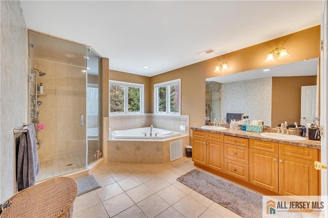 full bath with tile patterned flooring, a garden tub, a shower stall, and double vanity