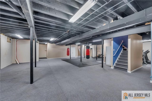 finished basement featuring stairway and carpet