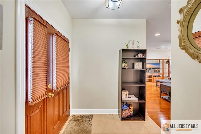 entryway with tile patterned floors, recessed lighting, and baseboards
