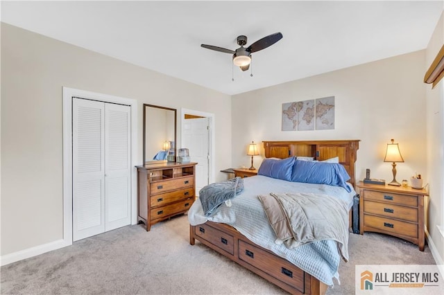 bedroom featuring light colored carpet, a closet, baseboards, and a ceiling fan