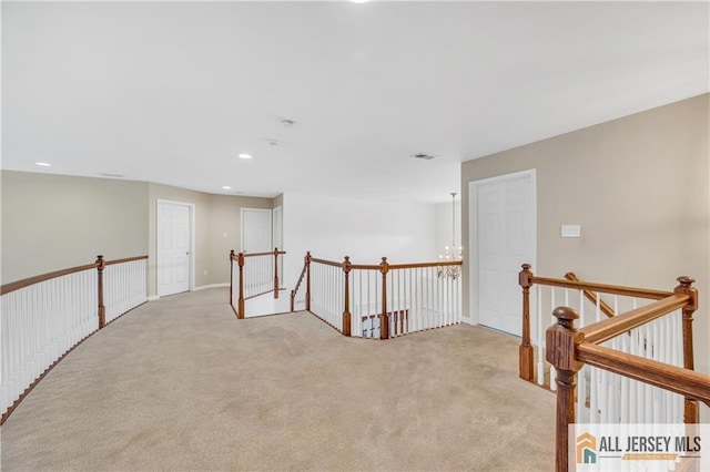 corridor featuring an upstairs landing, carpet, and recessed lighting