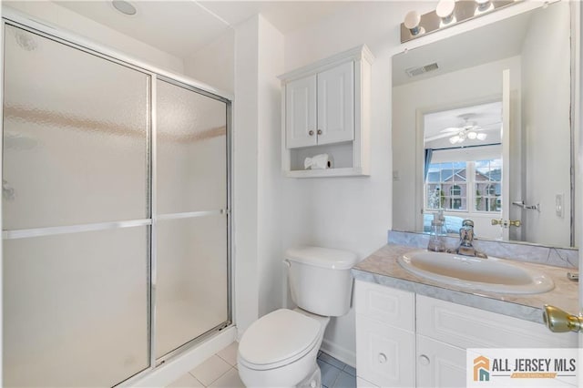 bathroom featuring toilet, a shower stall, vanity, tile patterned floors, and ceiling fan