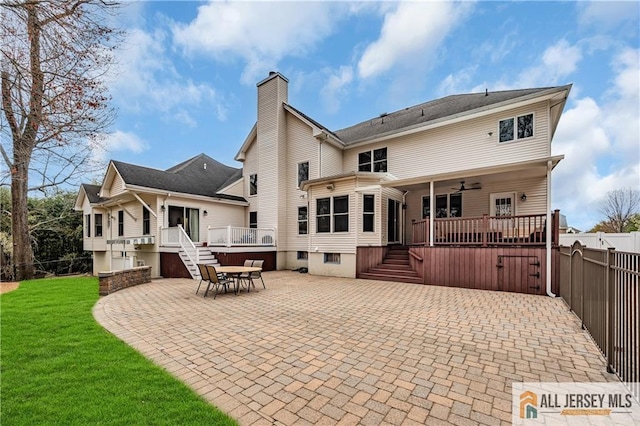 rear view of property with a chimney, a patio area, ceiling fan, a wooden deck, and stairway