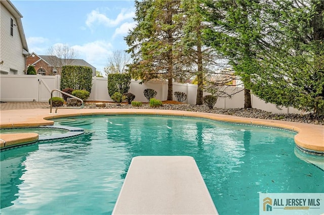 view of pool featuring a fenced backyard and a diving board