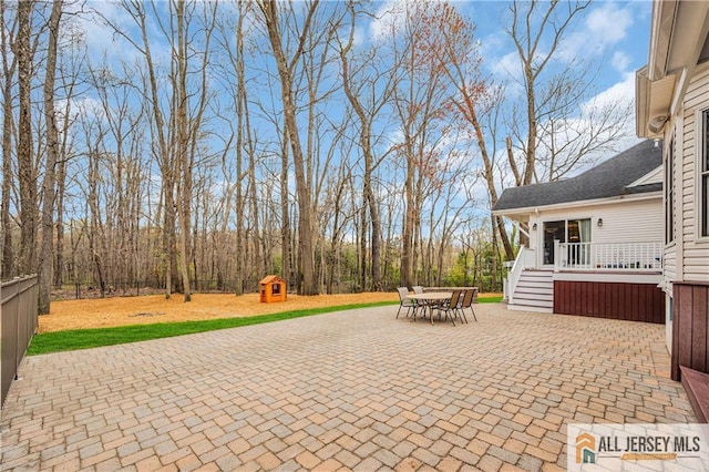 view of patio / terrace with outdoor dining area and a deck