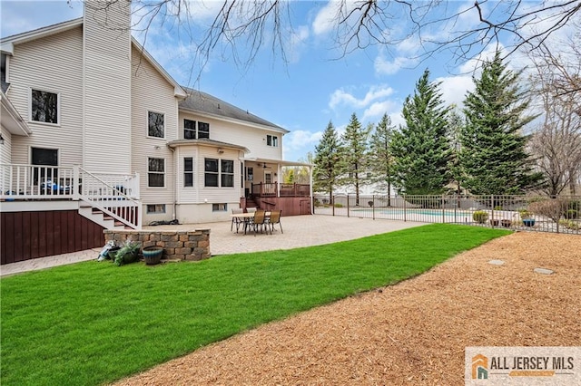 rear view of house featuring a patio and a chimney