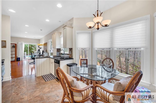 dining space featuring a chandelier, recessed lighting, and baseboards