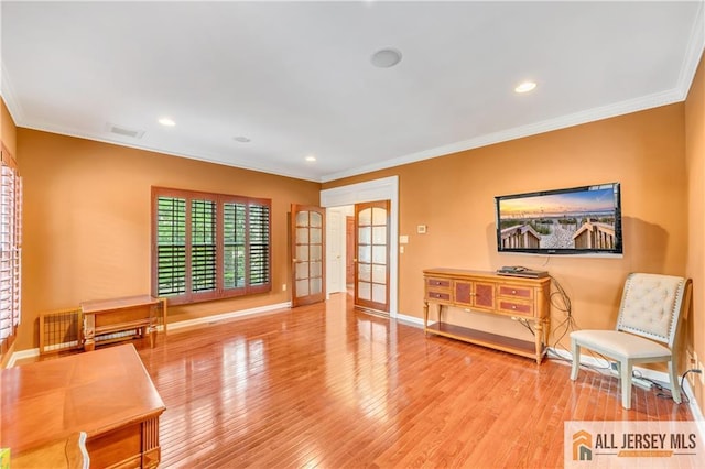 sitting room with ornamental molding, wood finished floors, baseboards, french doors, and recessed lighting