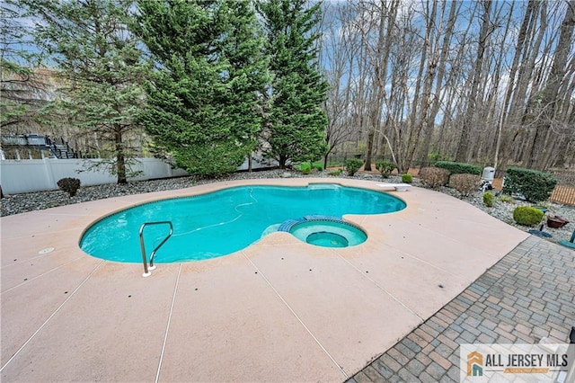 view of swimming pool with a fenced backyard, a patio, a diving board, and a pool with connected hot tub