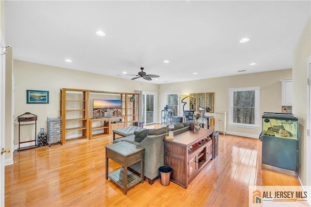 living area featuring light wood finished floors, a ceiling fan, recessed lighting, and baseboards