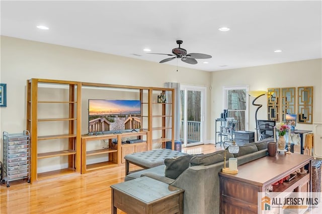 living area with a ceiling fan, wood finished floors, and recessed lighting