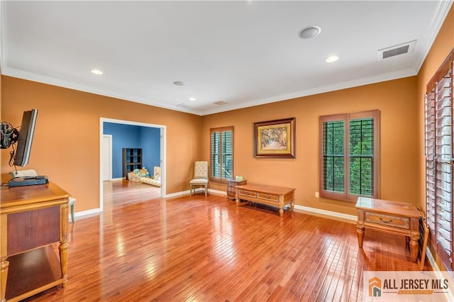 unfurnished room featuring crown molding, light wood finished floors, baseboards, and recessed lighting