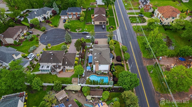 aerial view of property's location featuring nearby suburban area, a pool area, and property boundaries highlighted